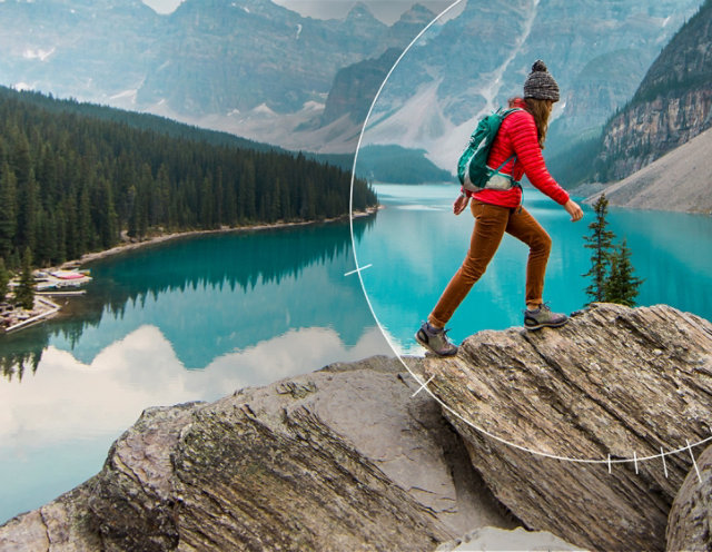 Photo of a wilderness hiker walking on top of. rock formation in front of a mountain lake featuring an aperture dial focused on the hiker and background terrain