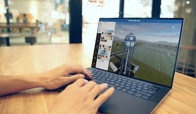 Person working on laptop computer using Water Tank Color Designer