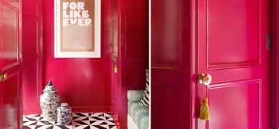 Bright pink walls with gold hardware on the doors.