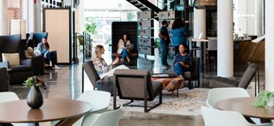 Large open space with people interacting on various furniture.