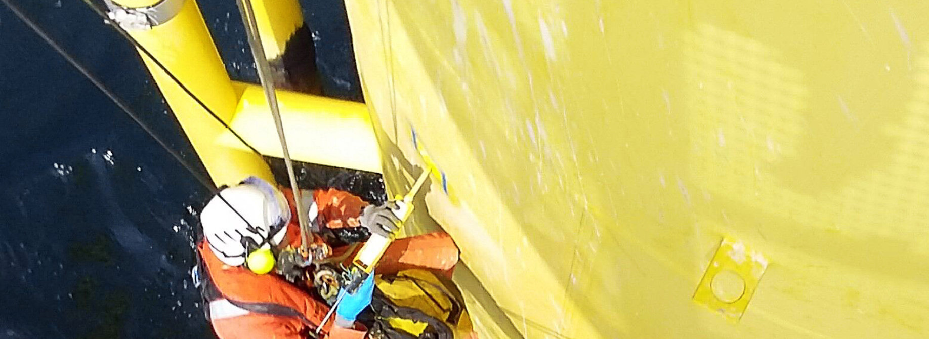 rope access technician conducts a a repair on a wind turbine tower