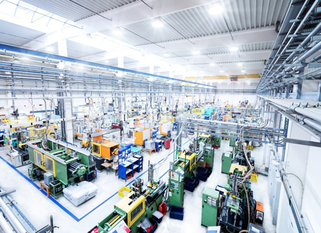 Interior of manufacturing facility with bright gray floors and blue line striping