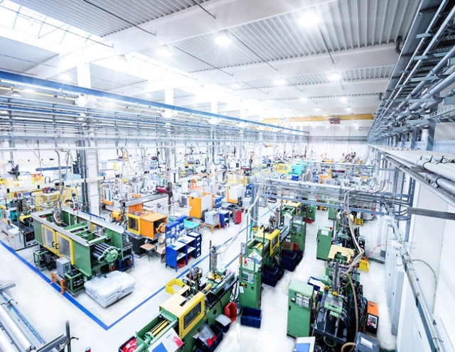 Interior of manufacturing facility with bright gray floors and blue line striping