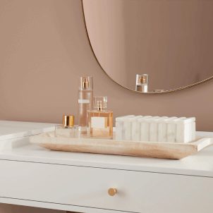 A white vanity against a wall painted Redend Point SW 9081 with an oval mirror above.