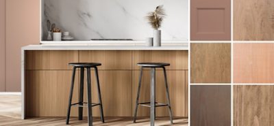 A bar top with black barstools against a white marble wall. Some neutral colored wood panels.