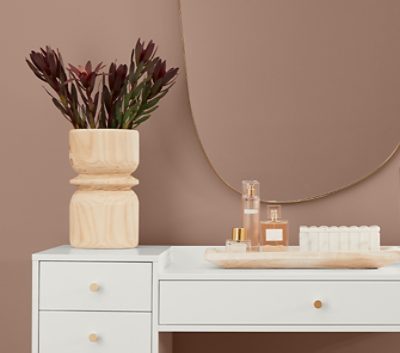 redend point walls with a white desk and wooden decor.