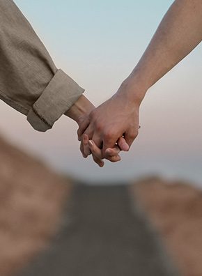 two people holding hands.