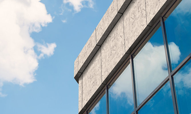 Retouched application image of a building exterior featuring Sherwin-Williams Emulate Stone Marble pattern panels in the Carrara colorway 