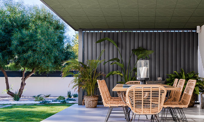 Retouched application image of an outdoor patio featuring Sherwin-Williams Emulate Metal Leaf pattern panels in the Fern colorway 