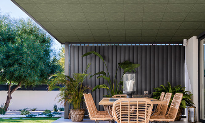 Retouched application image of an outdoor patio featuring Sherwin-Williams Emulate Metal Leaf pattern panels in the Fern colorway 