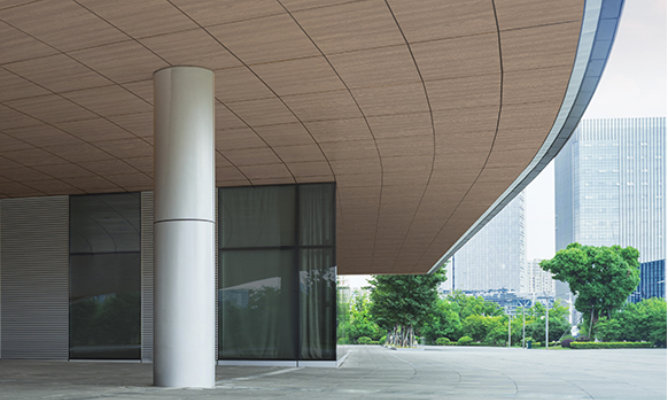 Retouched application image of a building soffit featuring Sherwin-Williams Emulate Wood Oak pattern panels in the Briarsmoke colorway 