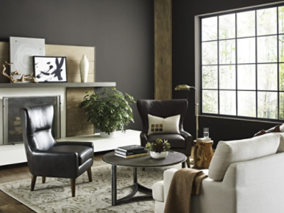 Living room with SW 7048 urbane bronze colored walls, dark leather chairs, wooden coffee table, and tan couch.