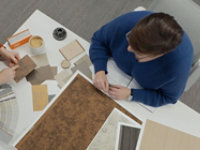 Birds eye photo of Sherwin-Williams design professionals reviewing different color swatch samples and patterns