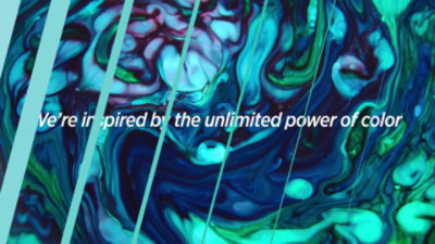 Green and blue ink swirling with "WE're inspired by the unlimited power of color" overlayed