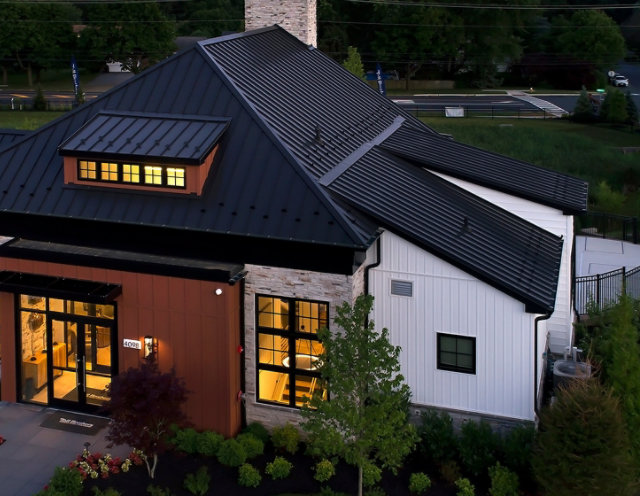 Aerial image of a community center clubhouse at dusk with installed metal roofing panels