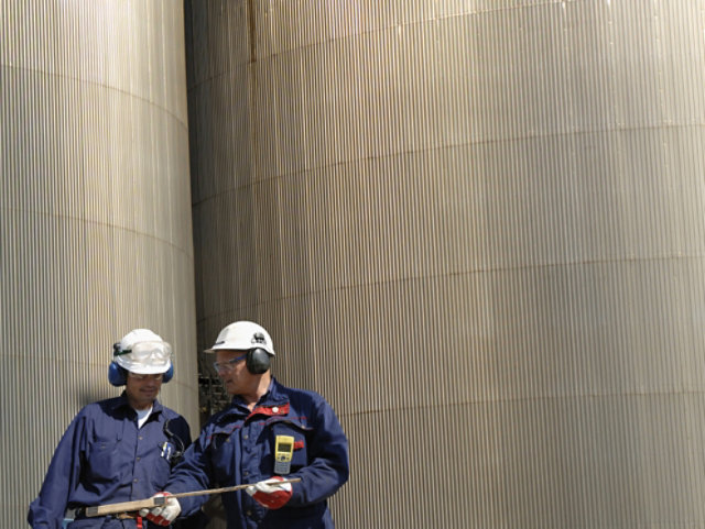 Engineers in front of treatment tanks