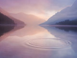 Photo of lake reflecting the mountains above