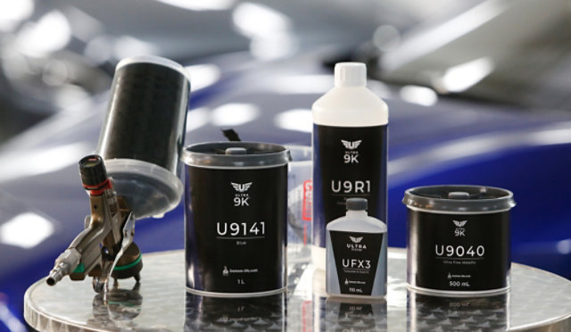 A selection of Ultra 9K products in front of a vehicle repairer in a bodyshop