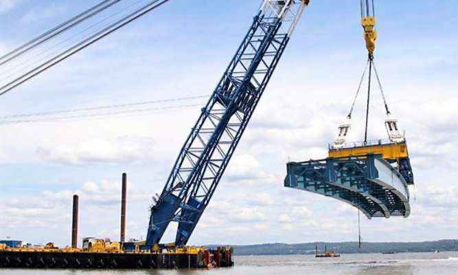 crane bringing in piece of bridge to be installed