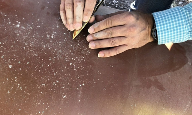 person inspecting rock drop test results