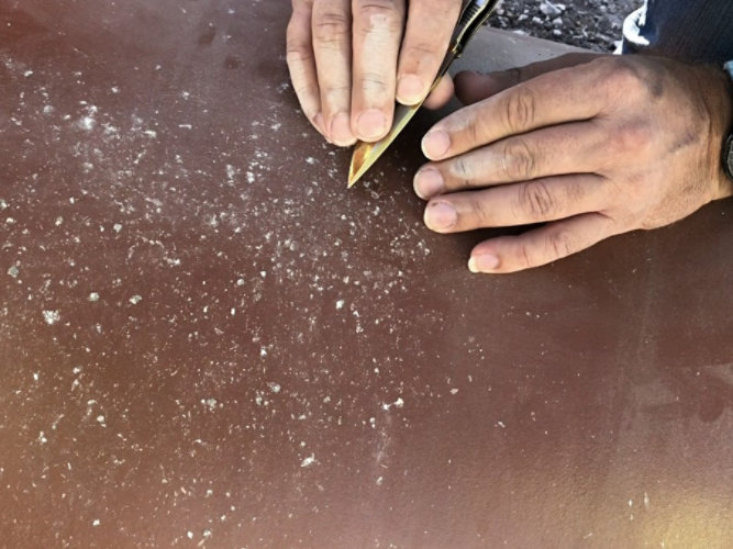 person inspecting rock drop test results