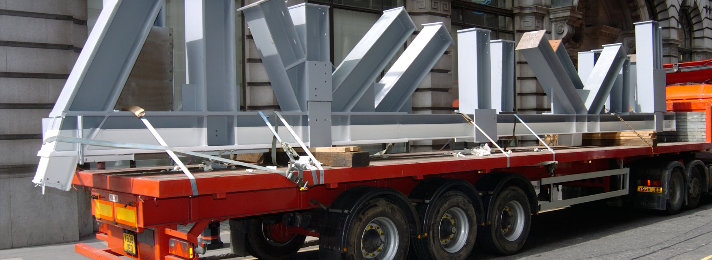 A truck transports steel to site
