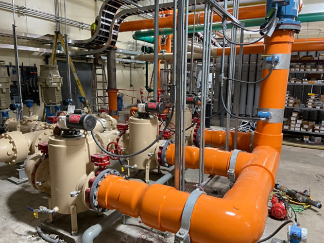 Wastewater treatment plant orange and tan pipes