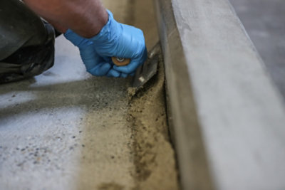 person applying cove base with cement trowel