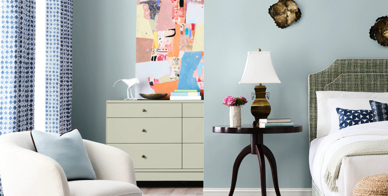 edroom interior with painted wood furniture and soft light blue walls.