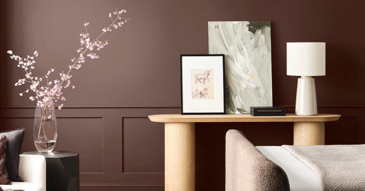 Bedroom interior with painted walls in dark warm brown and wood furnishings.
