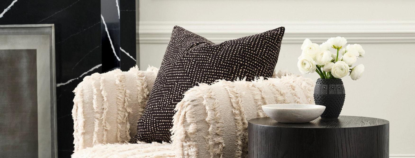 Living room detail with painted white walls and wood accent furniture.