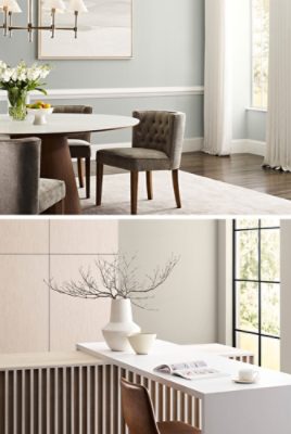 First image: Dining area with tufted round-back chairs, round table, vase of flowers and pedestal bowl with lemons, light green-gray walls with white trim and floor-to-ceiling white drapes. Second image: Light gray and neutral space with sleek modern cabinets without pulls, sculpted pendant light, white table with open book and teacup on saucer and leather-covered chair.