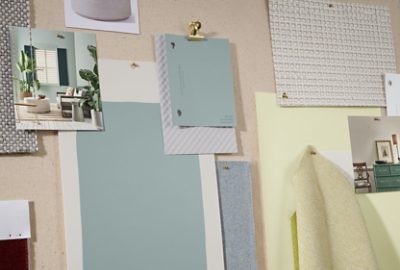 Pinboard with a photo of a room, paint color samples, drawdowns, and inspiration imagery in soft blues and yellows.