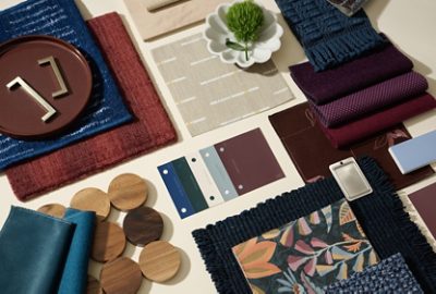 Flat lay featuring paint color samples, hardware, fabric swatches, and accessories in shades of blue, white, teal, and burgundy.