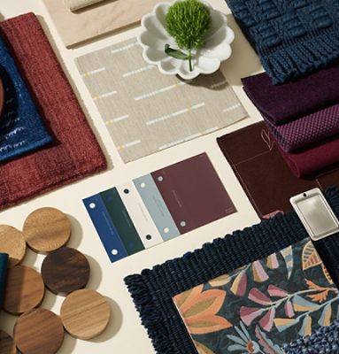Flat lay featuring paint color samples, hardware, fabric swatches, and accessories in shades of blue, white, teal, and burgundy.