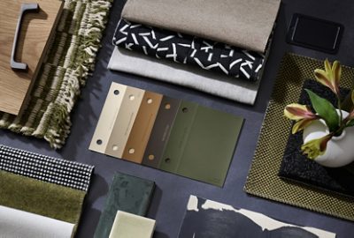 Flat lay of color samples, hardware, fabric swatches, and accessories featuring neutral tones and rich greens.
