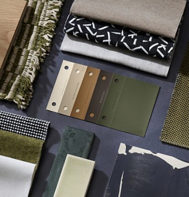 Flat lay of color samples, hardware, fabric swatches, and accessories featuring neutral tones and rich greens.