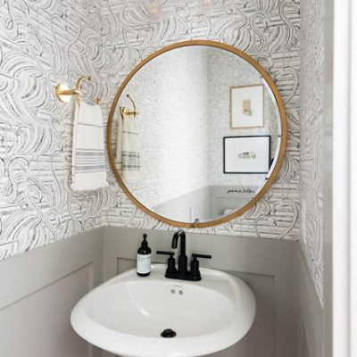 A white bathroom and vanity with flamingo designed wallpaper