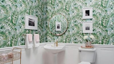 A tropical green wallpaper used in a bathroom
