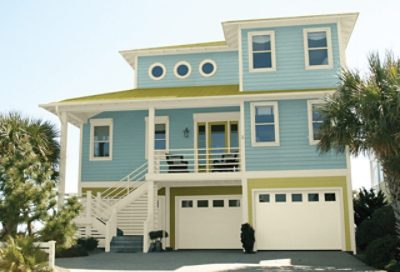 An aqua blue beach house with green roofing. S-W colors featured: SW 0019, SW 7564, SW 6416