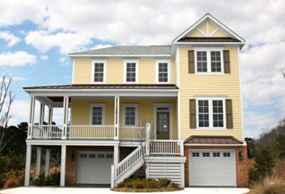 A banana cream beach house with rust colored roofing and white trim. S-W colors featured: SW 0019, SW 7564, SW 6416