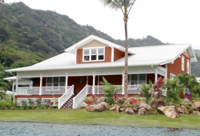 A painted red beach house with a white patio and white roofing. S-W colors featured: SW 7701, SW 7536, SW 6055
