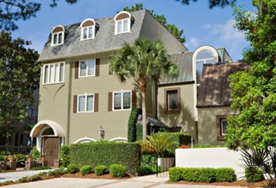 A green, modern beach house with traditional gray roofing. S-W colors featured: SW 7727, SW 7008, SW 6103