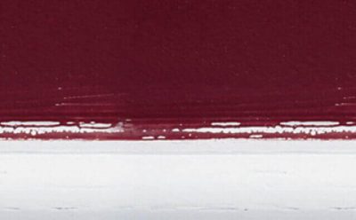 A section of cracked red and white paint.
