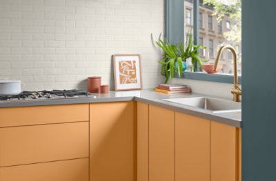 Kitchen cabinets painted in Bakelite Gold SW 6368.