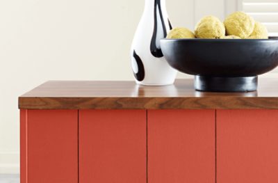 A medium-dark stained butcher block countertop painted Peppery SW 6615.
