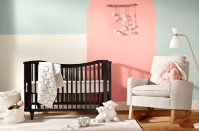 A nursery room with an accent wall painted Jovial SW 6611.