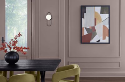 Dining room painted in Chinchilla SW 6011, minimal decor with green chairs and black table.