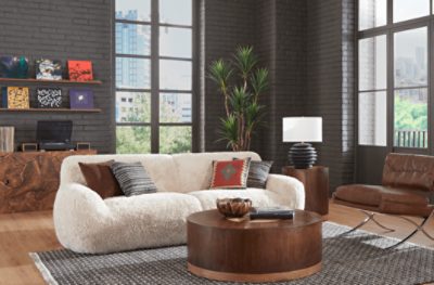 A room with high ceilings with tall windows in brick walls painted Sealskin SW 7675.