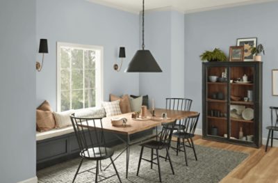 Dining room with a wooden table, black chairs, shelves, and walls painted SW 6233 Samovar Silver.